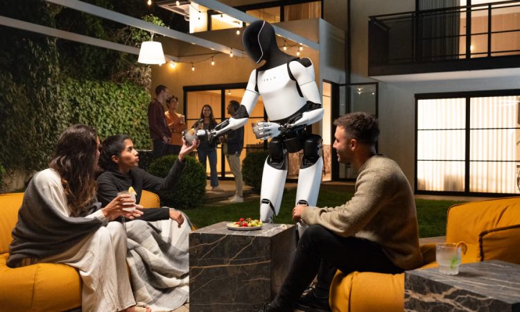 Rodney Brooks observing a humanoid walking robot, highlighting safety concerns in modern robotics